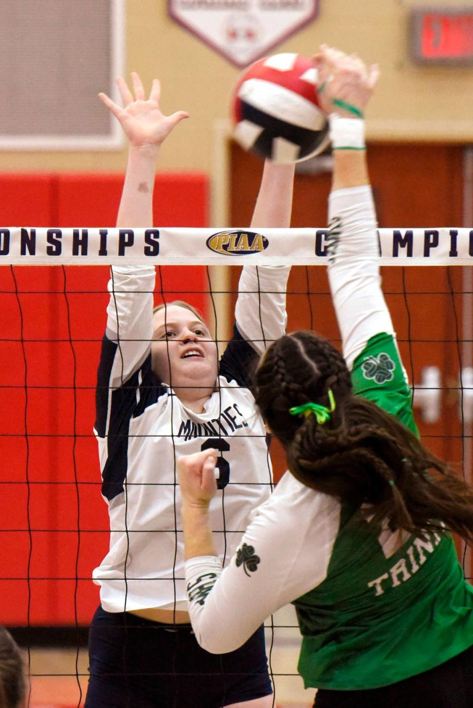 Philipsburg-Osceola’s Megan Johnson blocks the shot of Trinity’s Megan Zack. The Philipsburg-Osceola girls volleyball team won the PIAA Class 2A state championship Saturday at Cumberland Valley in Mechanicsburg. P-O defeated Trinity 3-1.