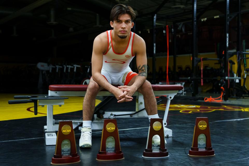 Pac-12 Wrestler of the Year, Brandon Courtney poses for a photo with four of his NCAA Division 1 trophies in the wrestling facilities at ASUÕs Tempe Campus on April 3, 2023.