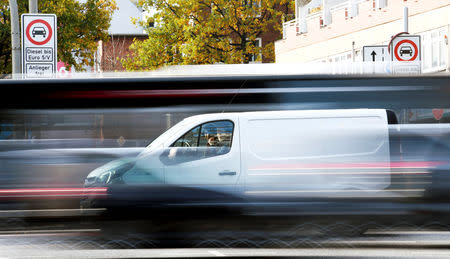 FILE PHOTO: Cars pass a traffic sign, which ban diesel cars at the Max-Brauer Allee in downtown Hamburg, Germany, November 8, 2018. REUTERS/Fabian Bimmer