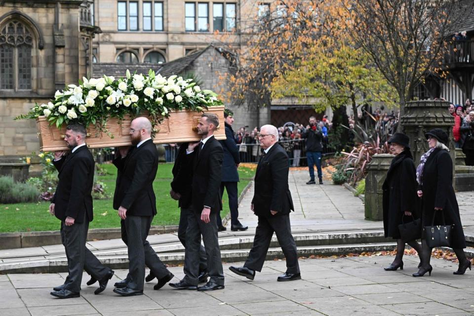 Lady Norma (second right), widow of Sir Bobby, walks behind the pallbearers (AFP/Getty)