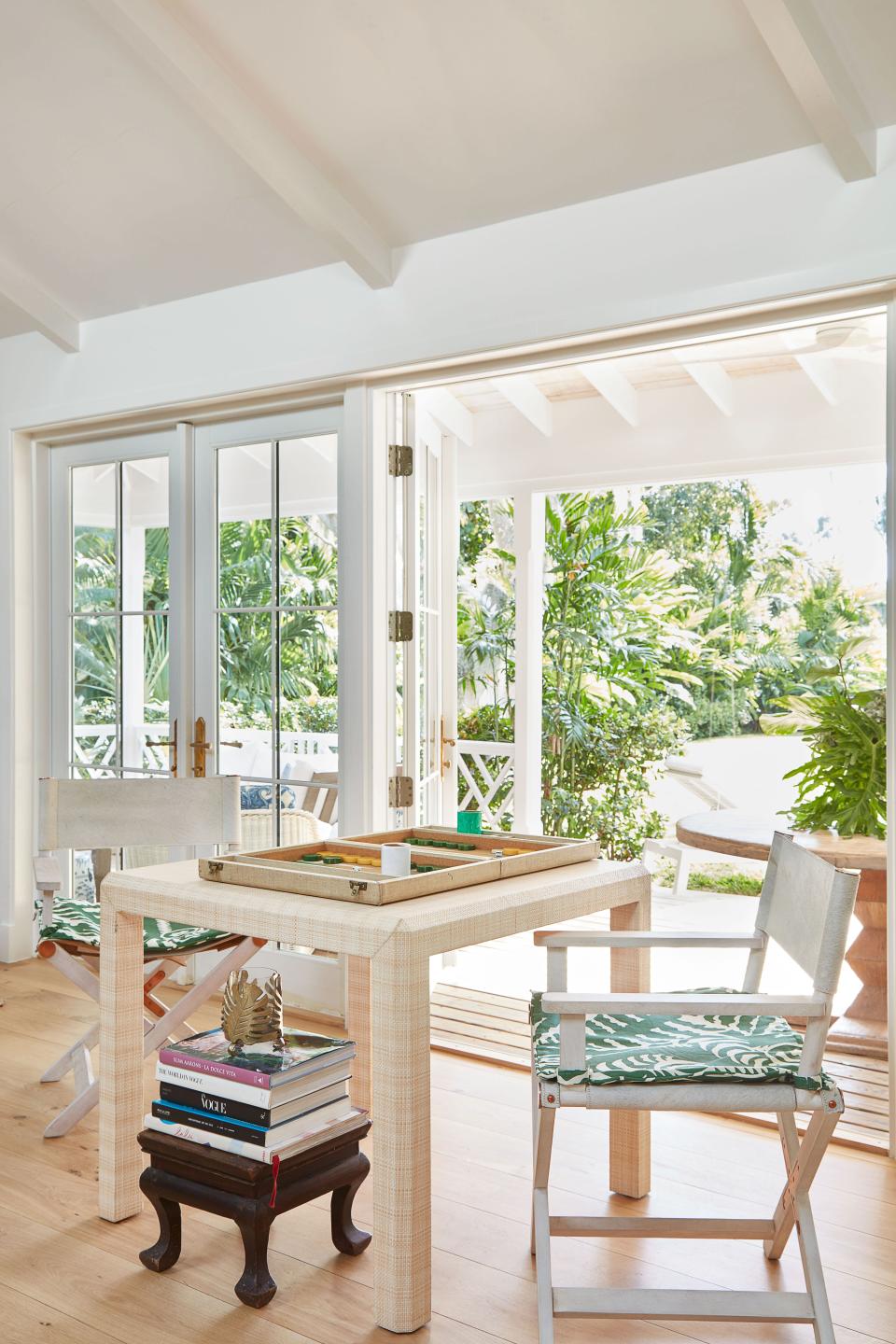CB2 director’s chairs pull up to a games table in Lulu de Kwiatkowski’s Bahamian home.