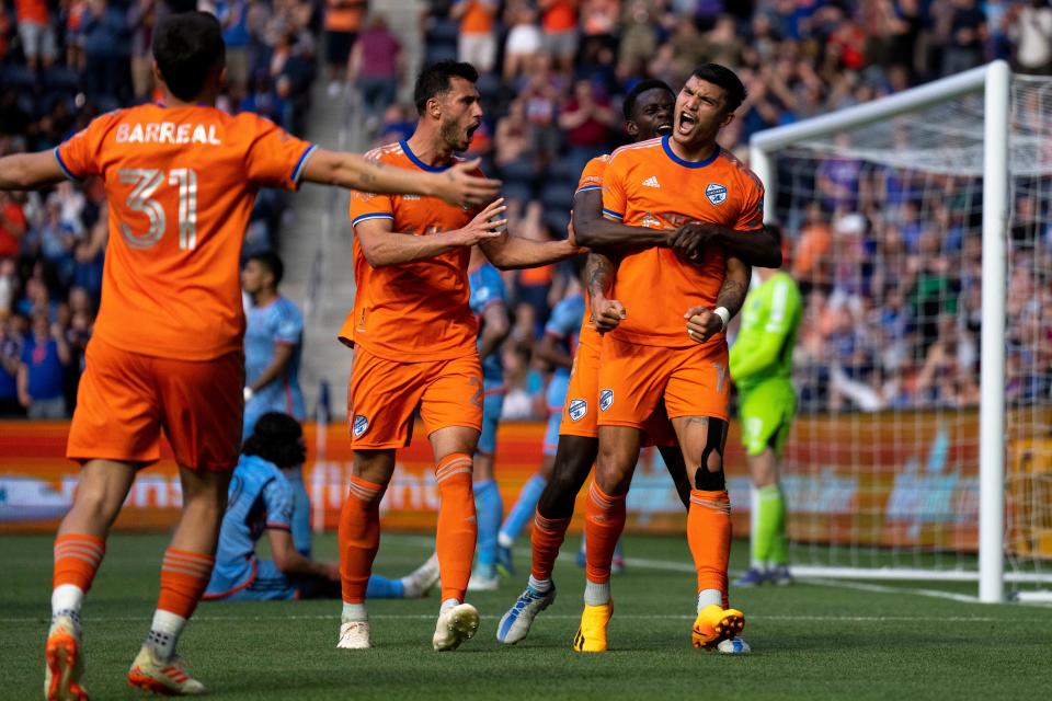 FC Cincinnati forward Dominique Badji (14) embraces FC Cincinnati forward Brandon Vázquez (19) after Vazquez’ goal in the 56 minute of the second half of the US Open Cup match between FC Cincinnati and New York City at TQL Stadium in Cincinnati on Wednesday, May 10, 2023. 