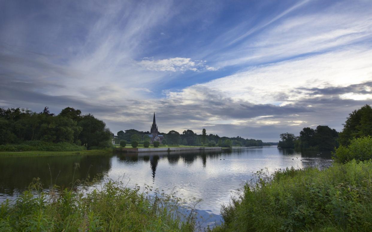 The spire of the Gothic chapel, seen in the distance, over the serpentine lake at Clumber Park - ©National Trust Images/David Noton