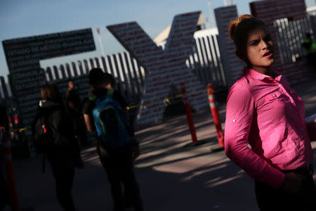 Evelyn Alexandra Salguero from Guatemala, part of a caravan of thousands from Central America tying to reach the United States, waits for her number in order to seek asylum at the Chaparral border crossing in Tijuana, Mexico, January 25, 2019. REUTERS/Shannon Stapleton