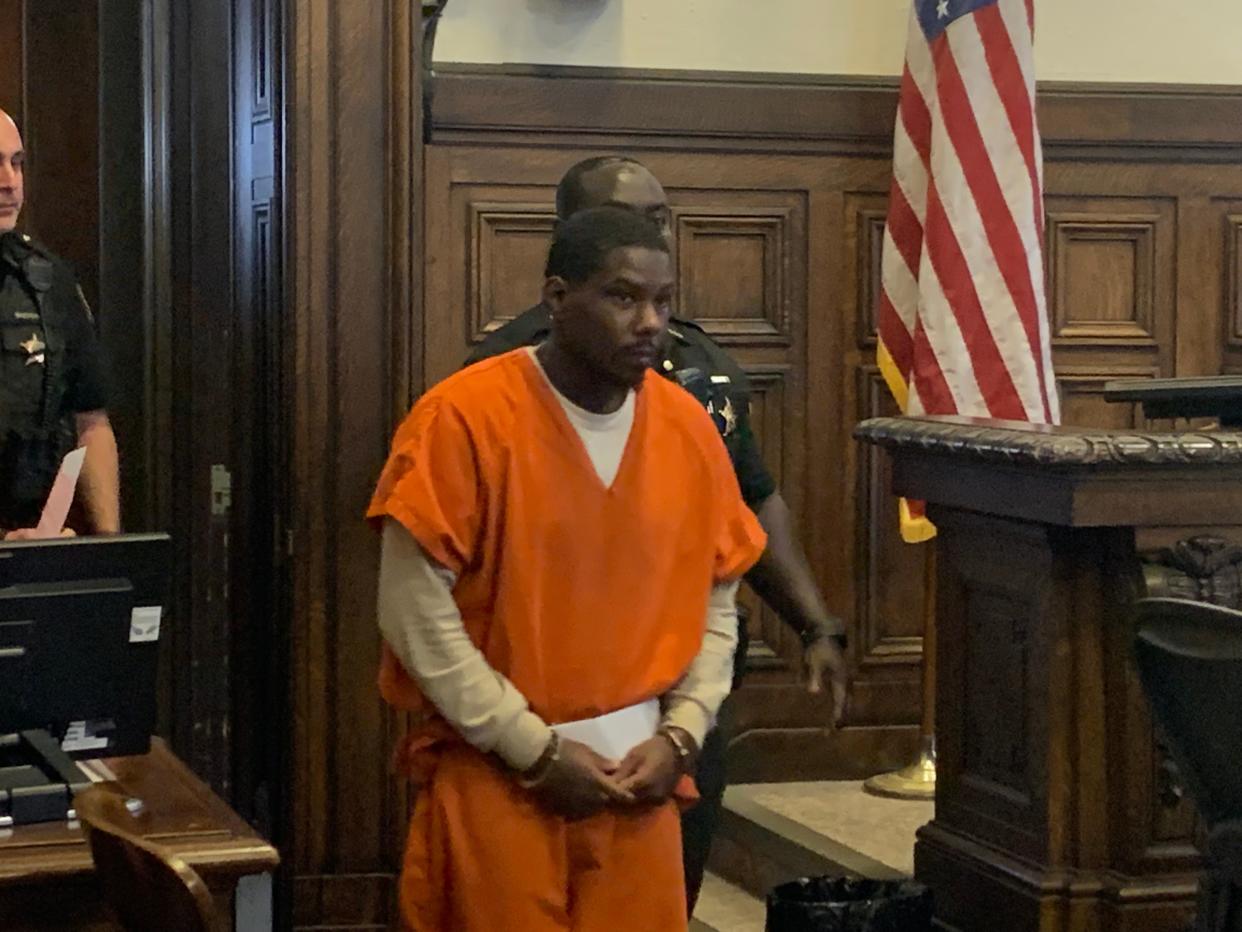 Kahlyl Powe walks into Summit County Common Pleas Judge Alison McCarty's courtroom Thursday. He was sentenced to life in prison for the murder of Kristopher Roukey.