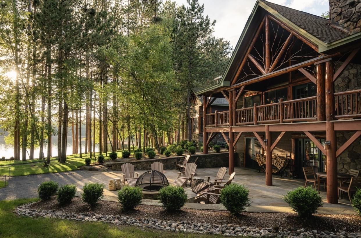 a house with a deck and trees around it