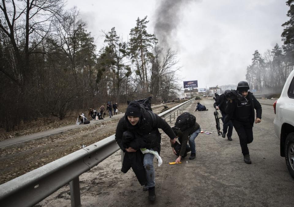 Civilians flee Irpin under fire last March, not long after the war started (Anadolu Agency/Getty)