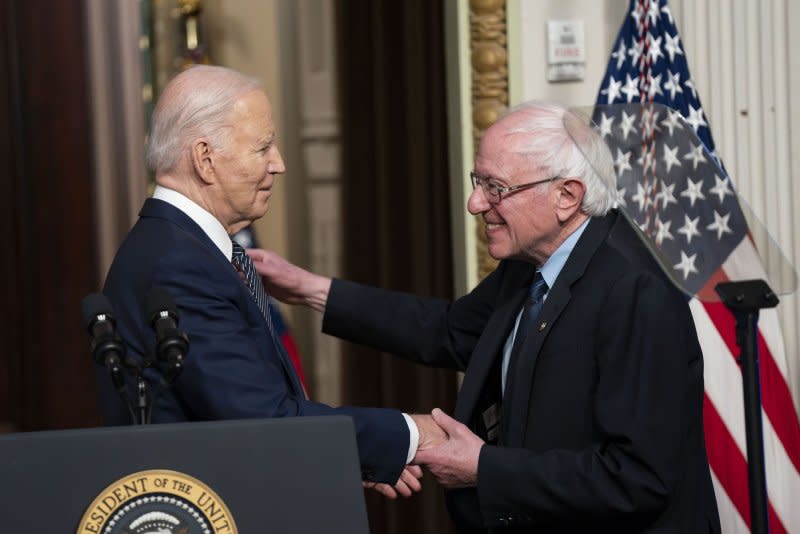 President Joe Biden and Sen. Bernie Sanders, I-Vt., greet each other Wednesday at a White House event touting their efforts to lower prescription drug costs, which they say Americans are "sick and tired of paying." Photo by Bonnie Cash/UPI