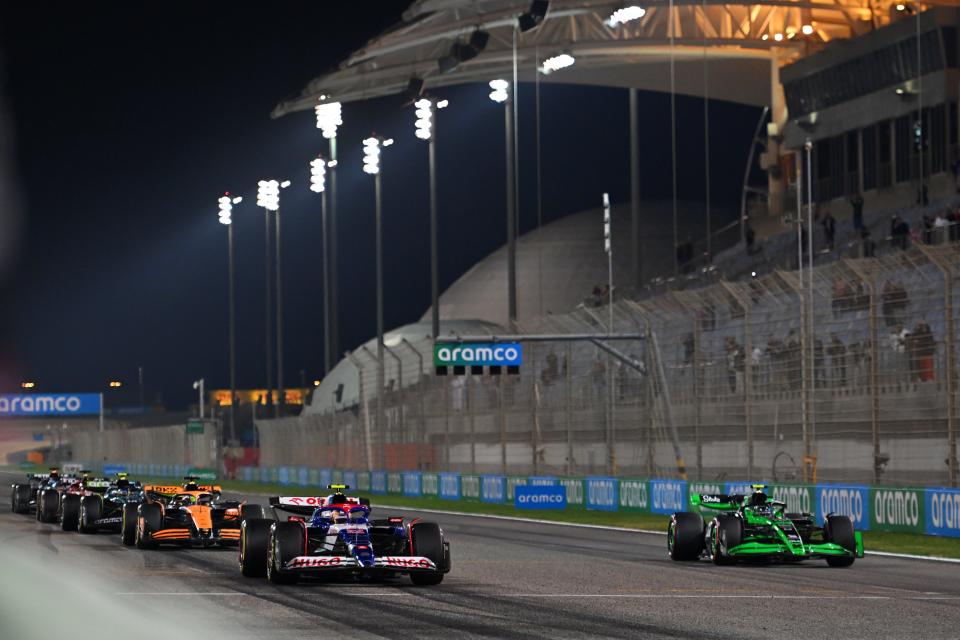 BAHRAIN, BAHRAIN - FEBRUARY 23: Yuki Tsunoda driving the (22) Visa Cash App RB VCARB 01 and Zhou Guanyu driving the (24) Kick Sauber C44 Ferrari line up on the front row of the grid to practice the start procedure. (Photo by Rudy Carezzevoli/Getty Images)