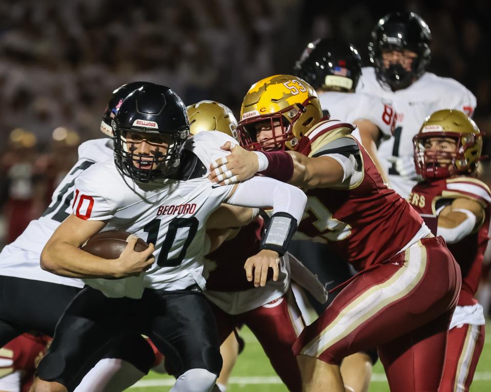 Portsmouth's Fletcher Miles (53) pulls down Bedford quarterback Danny Black during a Division I semifinal against Bedford this fall. Miles was named a Division I all-state first-team player.