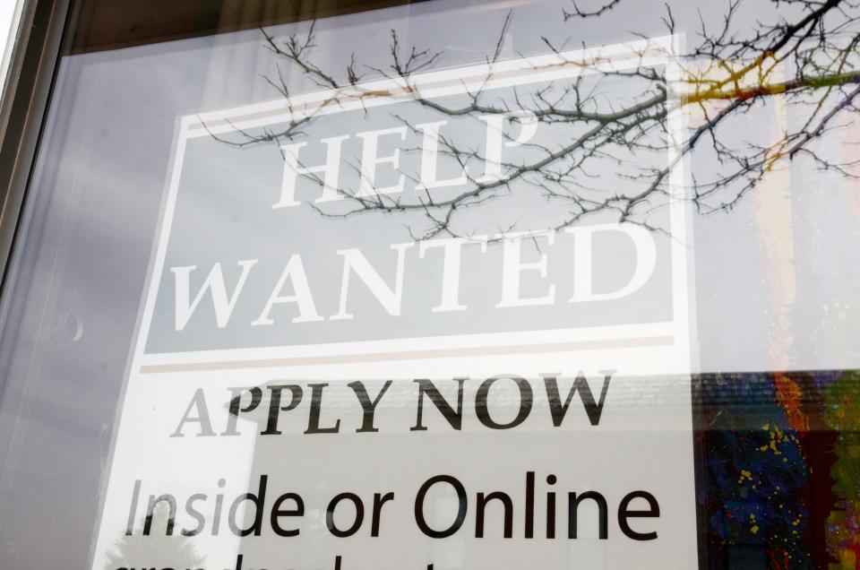 A help wanted sign hangs in a downtown Petoskey store.