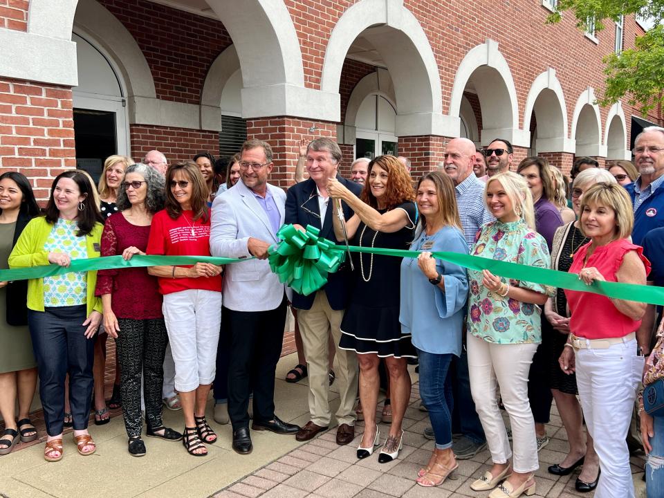 Local economic and governmental officials and Greater Gadsden Area Tourism staff join Executive Director Tina Morrison on Friday, May 3, 2024, in the ceremonial ribbon-cutting for the agency's new location in the Downtown Civic Center at 623 Broad St.