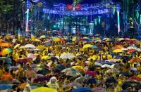 Thousands of Malaysian demonstrators turned central Kuala Lumpur yellow for a second straight day with a rally demanding Prime Minister Najib Razak's resignation over a corruption scandal, as the government threatened action against organisers