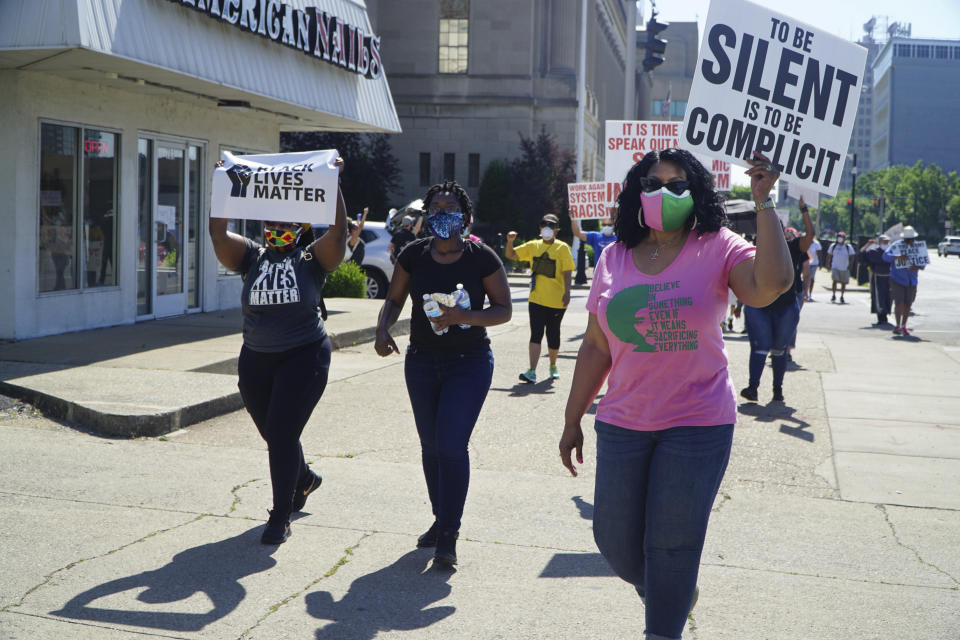 In this Saturday, June 6, 2020 photo provided by The Record, Black Catholics walk from the federal courthouse building in downtown Louisville, Ky., to 12th and Broadway, in the "Black Catholics Unite: Stand For Justice March" which was organized by young adults. Black Catholics across the U.S. hear their church’s leaders once again calling for racial justice, but at this volatile moment they want action as well as words. (Ruby Thomas/The Record via AP)