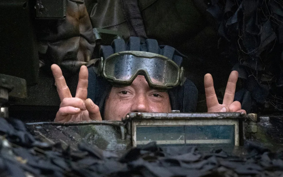 A Ukrainian tanker shows a victory sign at his position near Bakhmut - Efrem Lukatsky/AP