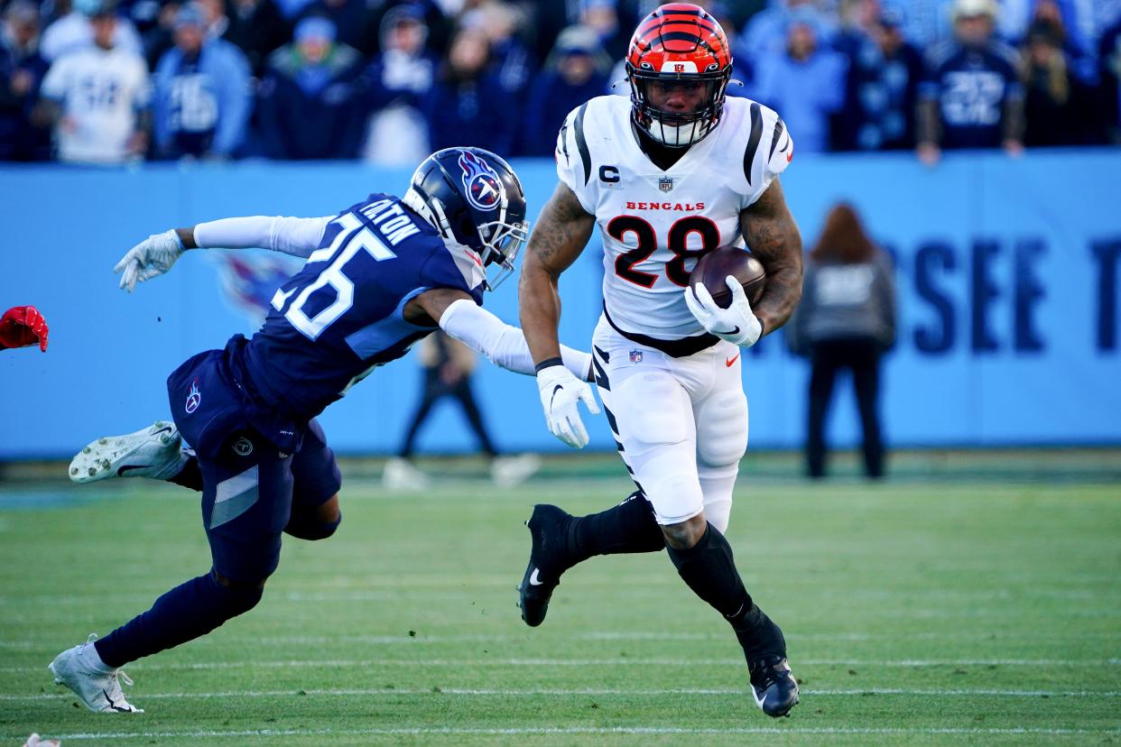 Cincinnati Bengals running back Joe Mixon (28) runs downfield after completing a catch in the first quarter during an NFL divisional playoff football game against the Tennessee Titans, Saturday, Jan. 22, 2022, at Nissan Stadium in Nashville.
