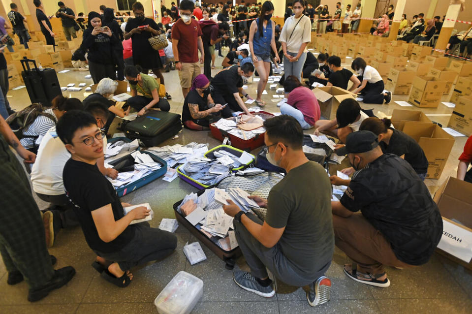 Volunteers unpack luggage filled with postal ballots from the UK on the eve of the Malaysian general election in Kuala Lumpur on Nov. 18, 2022.