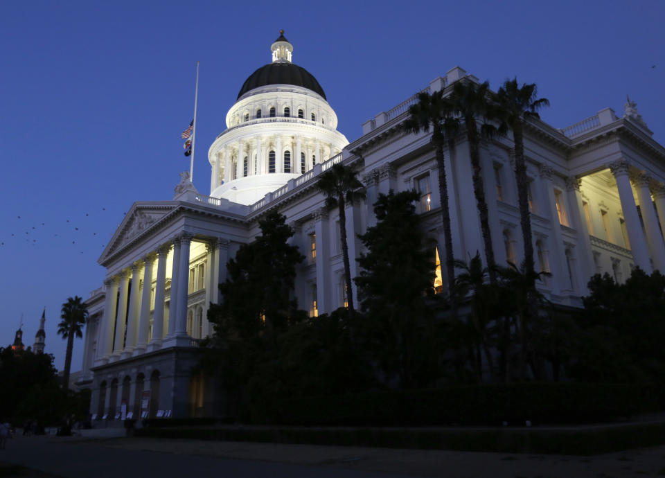 FILE - In this Aug. 31, 2018, photo the lights of the Capitol dome shine as lawmakers work into the night in Sacramento, Calif. California picked up an important partner its long-running dispute with the Trump administration over vehicle emissions and fuel economy by announcing a deal with Canada to work on pollution reductions. (AP Photo/Rich Pedroncelli, File)