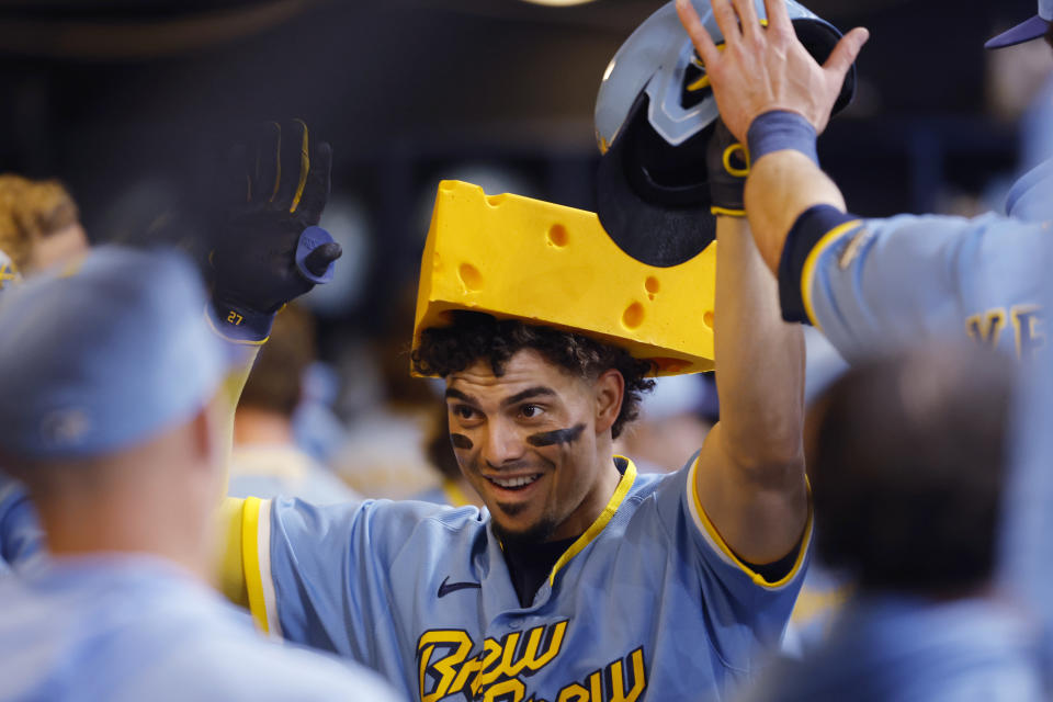 Milwaukee Brewers' Willy Adames wears a cheesehead after his home run against the Los Angeles Angels during the first inning of a baseball game Friday, April 28, 2023, in Milwaukee. (AP Photo/Jeffrey Phelps)