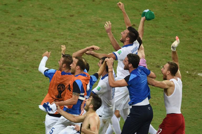 Greece's players celebrate at the end of the Group C football match between Greece and Ivory Coast at the Castelao Stadium in Fortaleza during the 2014 FIFA World Cup on June 24, 2014