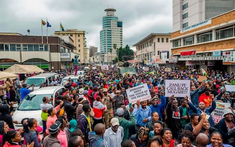 Protesters demanding the resignation of Robert Mugabwe in Harare - Credit: AFP