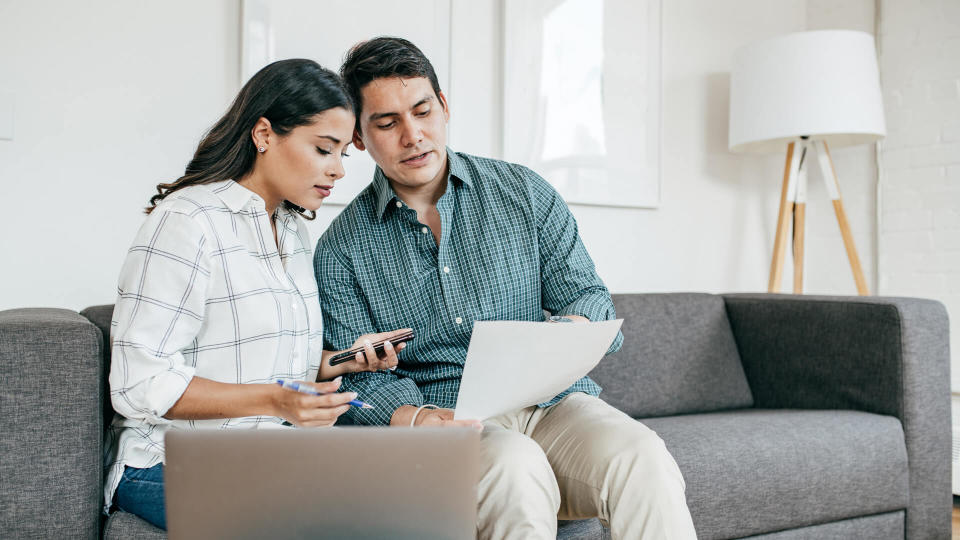 Couple looking on bank statements.