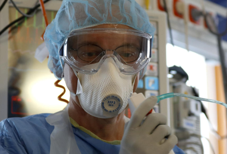 A healthcare worker during his shift at an intensive care unit (ICU) at the General University Hospital where patients infected with the COVID-19 are treated in Prague, Czech Republic, Tuesday, April 7, 2020. The new coronavirus causes mild or moderate symptoms for most people, but for some, especially older adults and people with existing health problems, it can cause more severe illness or death. (AP Photo/Petr David Josek)