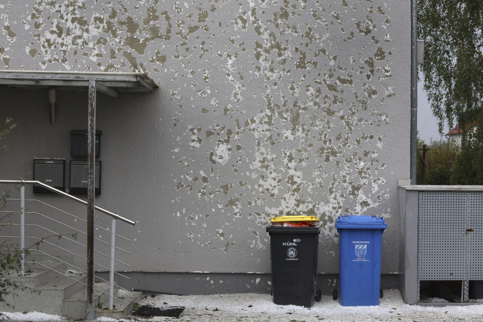 A house wall of an apartment building is damaged by hail in Kissing, Germany, Saturday Aug. 26, 2023. A storm with large hailstones damaged four-fifths of the buildings in a small town in the southern German state of Bavaria, local authorities said Sunday. The storm swept across the southern part of Bavaria on Saturday. In Kissing, just outside Augsburg, police said 12 people were injured when a beer tent that they were trying to put up was blown over. (Karl-Josef Hildenbrand/dpa via AP)