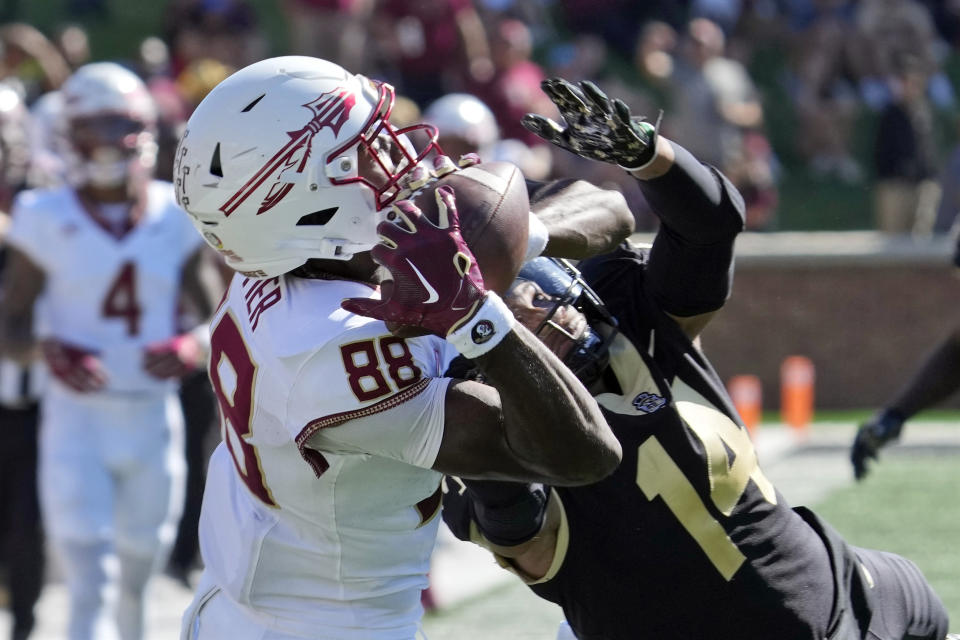 Florida State wide receiver Kentron Poitier (88) catches a pass as Wake Forest defensive back Evan Slocum (14) defends during the first half of an NCAA college football game in Winston-Salem, N.C., Saturday, Oct. 28, 2023. (AP Photo/Chuck Burton)