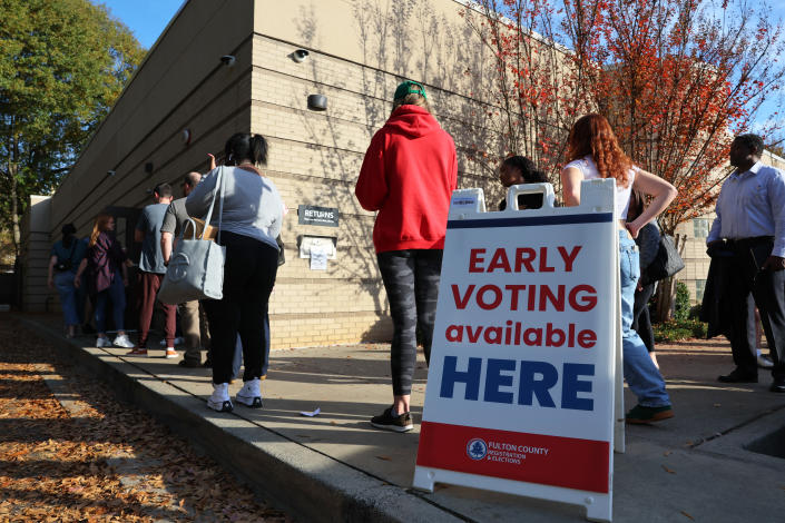 People wait in line for early voting