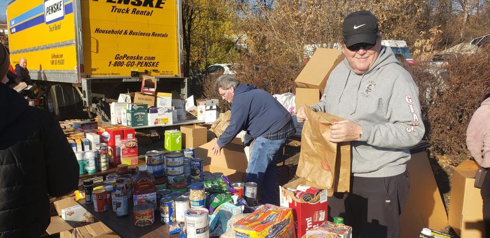 Volunteers pack roughly 750 Thanksgiving food baskets at MAG Auto Corp in the Town of Poughkeepsie Sunday.