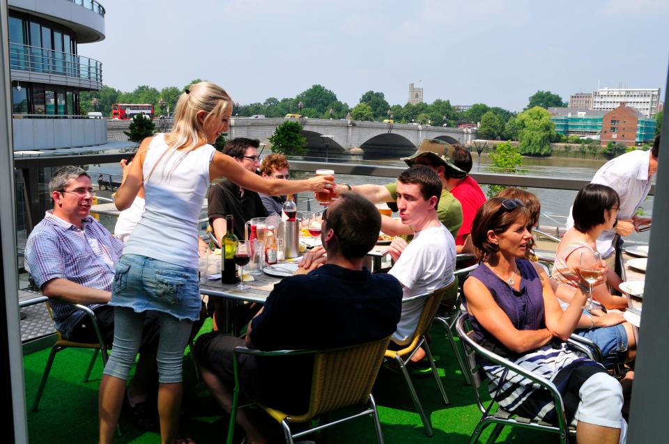 People chatting outside The Boathouse pub, Putney, London FTSE