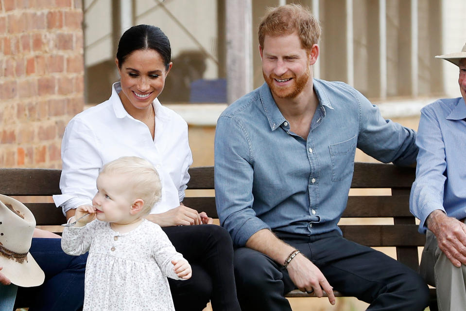 The royal couple watch on as a young fan innocently steals the show. Photo: Getty