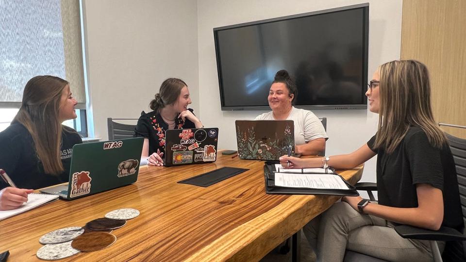 Dr. Chelsea Arnold, second from right, leads a meeting with student organizers of the Fall Gather, including Jayci Mekelburg, from left, Macy Downs and McKinley Begert.