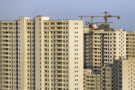 This July 6, 2019 photo shows residential towers in District 22, that consists of apartment high-rises and shopping malls arranged around an artificial lake called Chitgar, under construction on the northwestern edge of Tehran, Iran. Iran’s large middle class has been hit hard by the fallout from unprecedented U.S. sanctions, including the collapse of the national currency. Perhaps most devastating has been the doubling of housing prices. The spike has uprooted tenants and made home ownership unattainable for most. (AP Photo/Ebrahim Noroozi)