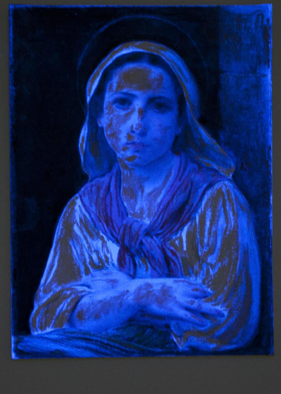 A black light shows the deception behind a forgery by art forger Mark A. Landis, of Laurel, Miss. of an original work by 19th-century French painter William-Adolphe Bouguereau, at the University of Cincinnati in Cincinnati, Ohio on Tuesday, March 27, 2012. The work of the convincing art forger who has spent nearly three decades copying artists like Picasso and donating his fake art to unsuspecting museums goes on display April Fool's Day. The University of Cincinnati exhibit will explore the problem of art forgery through a look at the unusual story of Landis. (AP Photo/Dottie Stover-University of Cincinnati)