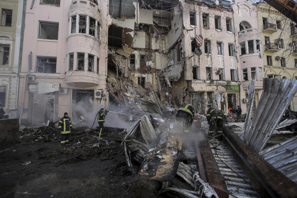 Firefighters extinguish an apartment house after a Russian rocket attack in Kharkiv, Ukraine's second-largest city, Ukraine, Monday, March 14, 2022. (AP Photo/Pavel Dorogoy)