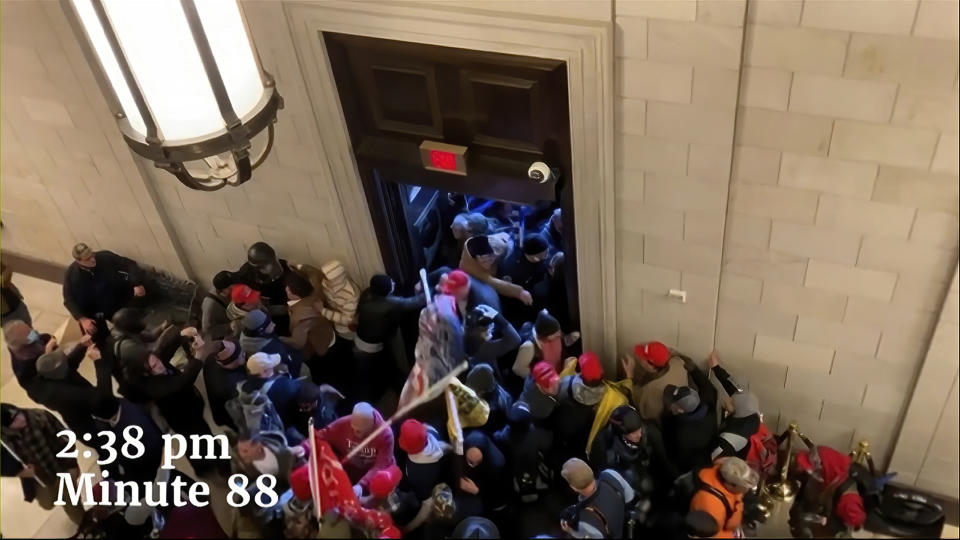 This exhibit from video released by the House Select Committee, shows rioters inside the Capitol on Jan. 6, displayed at a hearing by the House select committee investigating the Jan. 6 attack on the U.S. Capitol, Thursday, July 21, 2022, on Capitol Hill in Washington. (House Select Committee via AP)