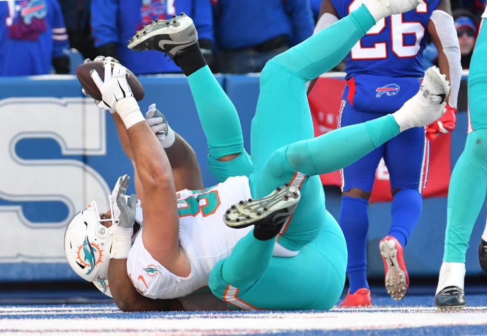 Jan 15, 2023; Orchard Park, NY, USA; Miami Dolphins defensive tackle Zach Sieler (92) recovers a fumble for a touchdown against the Buffalo Bills during the second half in a NFL wild card game at Highmark Stadium. Mandatory Credit: Mark Konezny-USA TODAY Sports