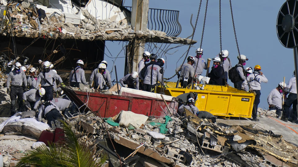 Workers search the rubble at the Champlain Towers South Condo, Monday, June 28, 2021, in Surfside, Fla. Many people were still unaccounted for after Thursday's fatal collapse. (AP Photo/Lynne Sladky)