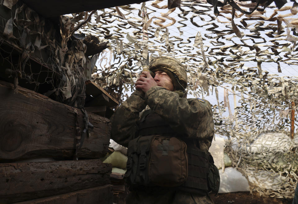 A Ukrainian soldier at a fighting position on the line of separation from pro-Russian rebels near Debaltsevo, Donetsk region, Ukraine, Ukraine Friday, Dec 3, 2021. In this Friday, the Ukrainian defense minister warned that Russia could invade his country next month. Russia-West tensions escalated recently with Ukraine and its Western backers becoming increasingly concerned that a Russian troop buildup near the Ukrainian border could signal Moscow's intention to invade. (AP Photo/Andriy Dubchak)