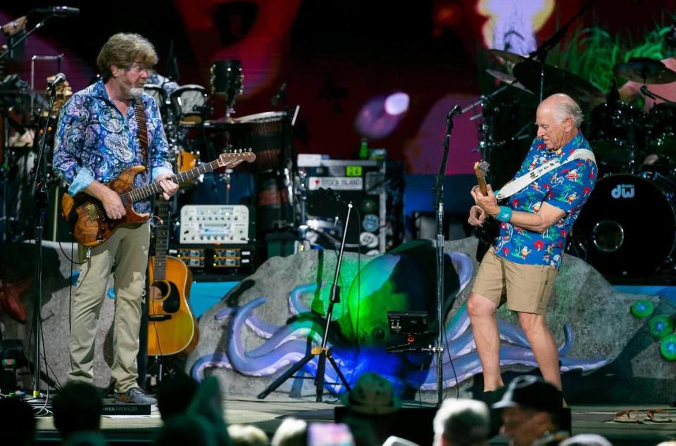 Jimmy Buffett (right) and his Coral Reefer Band, including Mac McAnally (left), perform during their concert at the iTHINK Financial Amphitheatre near West Palm Beach, Florida on Thursday, Dec. 9, 2021.