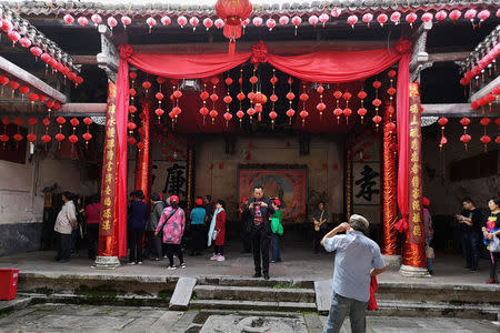 Tourists visit an ancestral hall in Rucheng county, Hunan province, China December 3, 2018. Picture taken December 3, 2018. REUTERS/Shu Zhang