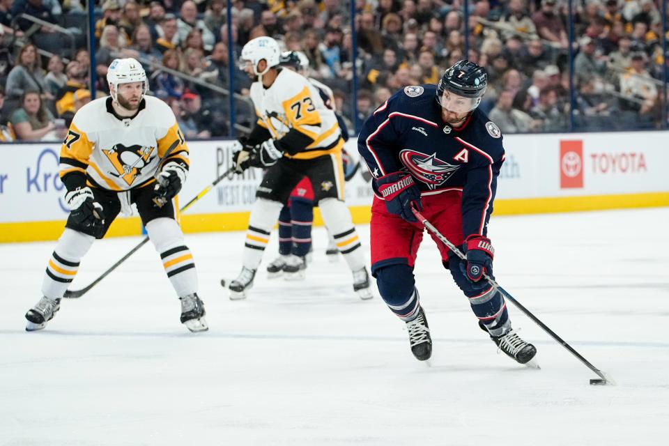 Columbus Blue Jackets center Sean Kuraly (7) shoots in front of Pittsburgh Penguins right wing Bryan Rust (17) during the first period of the NHL hockey game at Nationwide Arena on April 13, 2023.