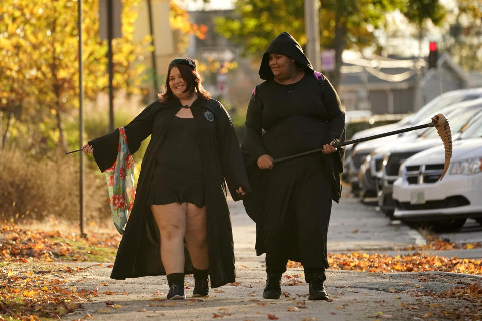 The Halloween holiday brightens the spirits of Lewiston residents Taylor Boucher and Salyrika Pahl in the wake of last week's mass shootings, Tuesday, Oct. 31, 2023, in Lewiston, Maine. (AP Photo/Robert F. Bukaty)