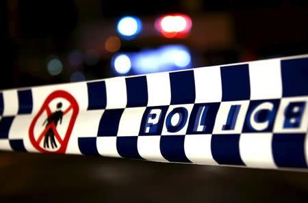 Police tape stretches across a road as police inspect and guard the area outside the New South Wales (NSW) state police headquarters located in the south western Sydney suburb of Parramatta, Australia, October 2, 2015. REUTERS/David Gray