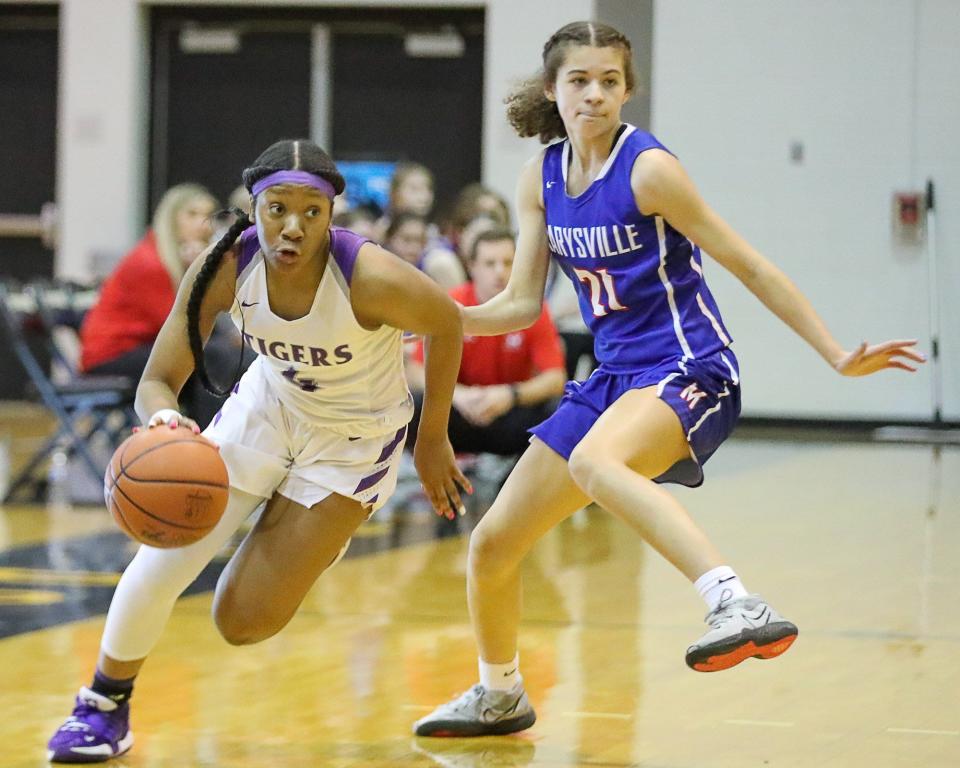 Pickerington Central's Madison Greene drives around Marysville's JoJo Eberhart during a Division I district final last season. Greene has been named OCC-Buckeye Player of the Year and Eberhart has been named OCC-Cardinal Player of the Year.