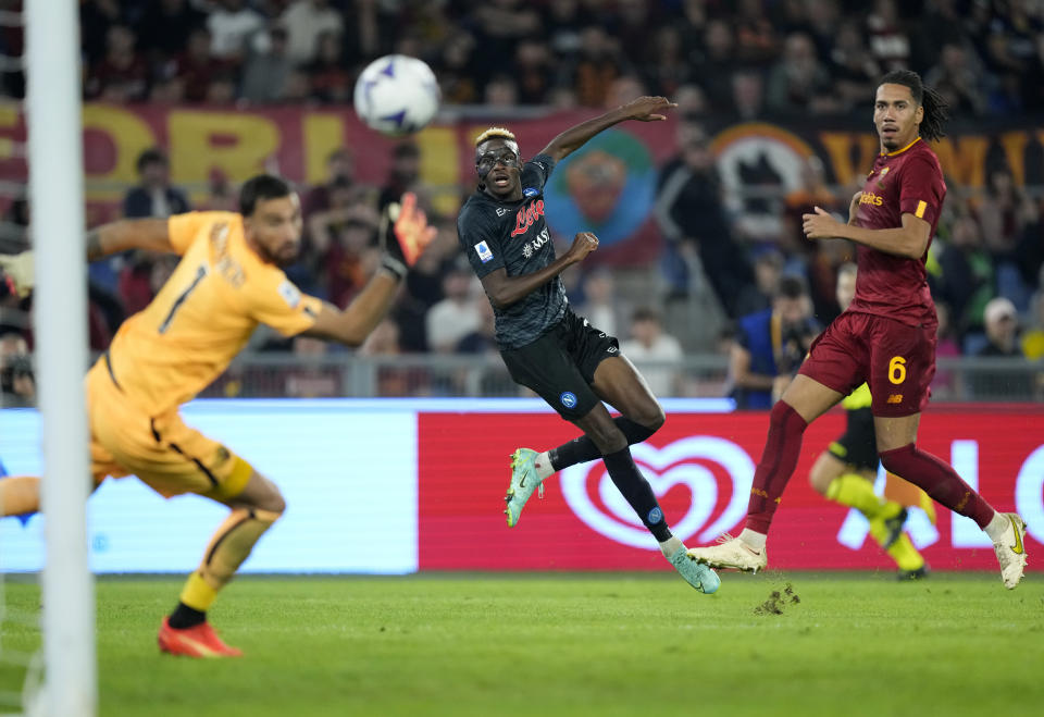 Napoli's Victor Osimhen, center, scores his side's opening goal during a Serie A soccer match between Roma and Napoli, at the Olimpic stadium in Rome, Sunday, Oct. 23, 2022. (AP Photo/Andrew Medichini)