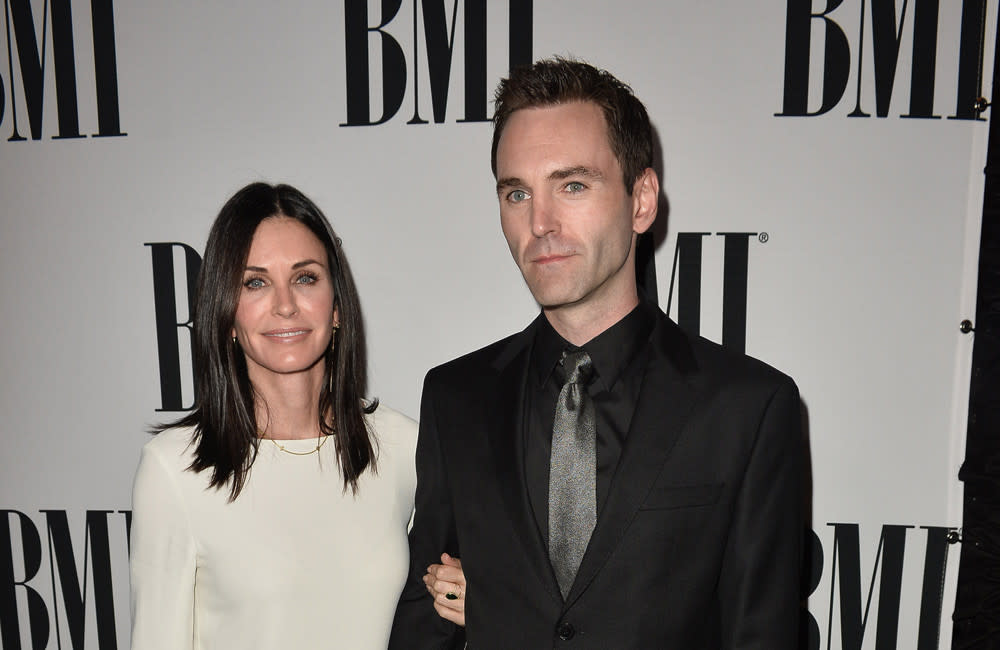 Courtney Cox reveals how a string of celebrity friends got her together with Johnny McDaid credit:Bang Showbiz