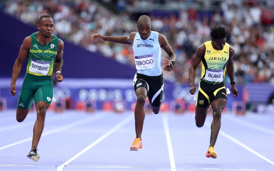 Akani Simbine of South Africa beats Botswana's Letslie Tebogo into second